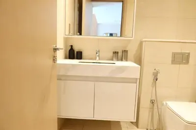 a bathroom with a white sink and a mirror at Minteh Holiday Home in Dubai