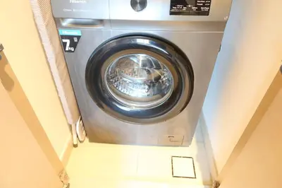 a washing machine in a room with the door open at Minteh Holiday Home in Dubai
