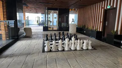 a giant chess set on the floor of a building at Bayz by Danube by That Place Home Living in Dubai