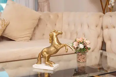 a gold dog statue on a table in front of a couch at Elite Royal Apartment - Full Burj Khalifa & New Fountain View - Panoramic - Luxurious - Magnus in Dubai
