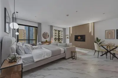 a living room with a large bed and a table at Beachfront Studio JBR - Murjan 2 by Home Of Choice in Dubai