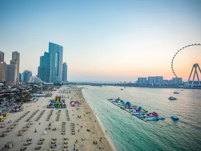 a beach with a lot of people and a ferris wheel at Beachfront Studio JBR - Murjan 2 by Home Of Choice in Dubai