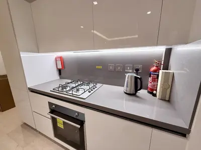 a kitchen with a stove and a counter top at 2 BR with Full Burj View 10 min Walk to Dubai Mall in Dubai
