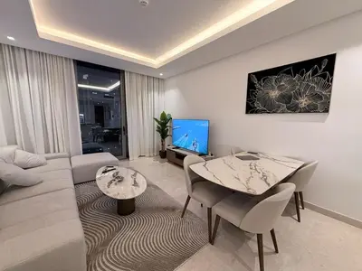 a living room with a couch and a table at 2 BR with Full Burj View 10 min Walk to Dubai Mall in Dubai