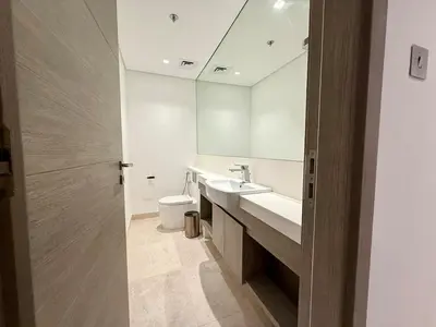 a bathroom with a sink and a toilet and a mirror at 2 BR with Full Burj View 10 min Walk to Dubai Mall in Dubai