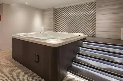 a bathroom with a bath tub in a room at C&L Homes with Burj Khalifa view in Dubai