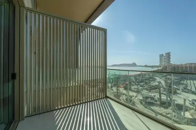 a balcony in a building with a view of a city at Ultra Luxury 2BD Beachfront & Panoramic Sea Views in Dubai