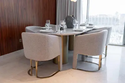 a dining room table with chairs and wine glasses at Ultra Luxury 2BD Beachfront & Panoramic Sea Views in Dubai
