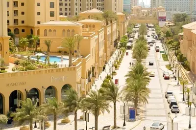 a street in a city with palm trees and buildings at Royal Marina Inn in Dubai
