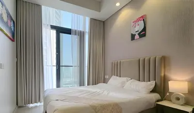 a bedroom with a bed and a large window at Stunning 2 Bedroom Aykon City Tower C in Dubai