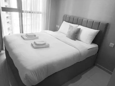 a large bed with two towels on top of it at Stunning 2 Bedroom Aykon City Tower C in Dubai