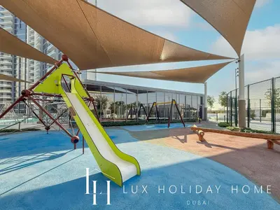 a slide in a park with a playground at LUX The Burj Khalifa Lagoon View Suite 5 in Dubai