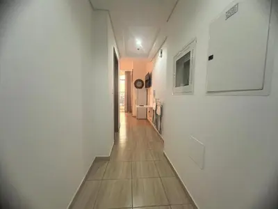 a hallway with white walls and a wooden floor at Burj Sabah in Dubai