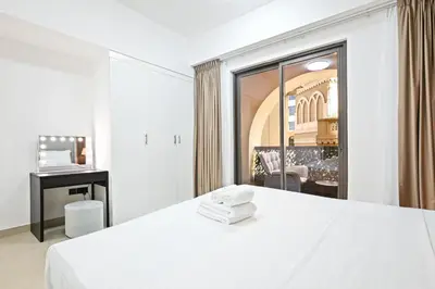 a white room with a bed and a window at Spacious 4BR in JBR Steps to Beach & Walk in Dubai