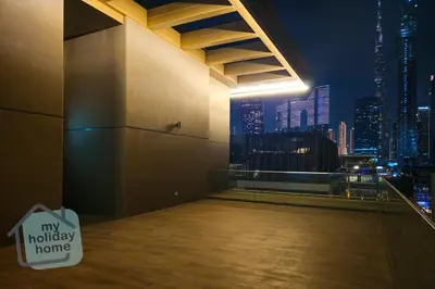 a room with a view of a city at night at Burj Khalifa View from Roof-Pool & Gym -Parking in Dubai