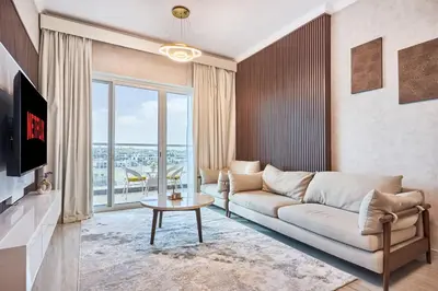 a living room with a couch and a table at 2 Bedroom Apartment Close to Miracle Tower in Dubai