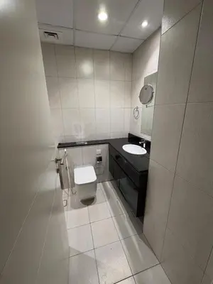 a bathroom with a toilet and a sink at Luxury Living In JVC in Dubai