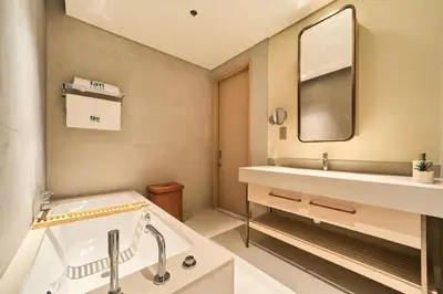a bathroom with a tub and a sink and a mirror at Iconic 2BR Vida Dubai Mall with Direct Mall Access in Dubai