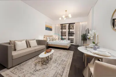 a living room with a couch and a table at Studio Just Minutes Drive to Downtown Dubai Top Attractions, Close to Zabeel Stadium, O10 Building, Al Jaddaf by Deluxe Holiday Homes in Dubai