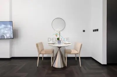 a table with chairs and a mirror on a wall at Studio Just Minutes Drive to Downtown Dubai Top Attractions, Close to Zabeel Stadium, O10 Building, Al Jaddaf by Deluxe Holiday Homes in Dubai