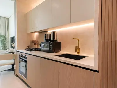 a kitchen with a sink and a microwave at WelHome - Perfect Cozy Studio with Pool, Gym & Balcony in Dubai
