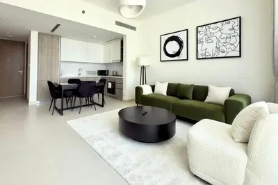 a living room with a green couch and a table at Modern 1 Bed Apartment with full Dubai Marina view in Dubai