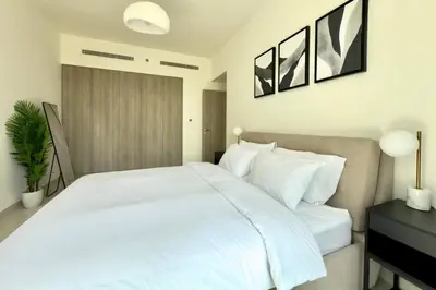 a bedroom with a large white bed and a black desk at Modern 1 Bed Apartment with full Dubai Marina view in Dubai