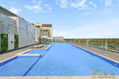 a swimming pool on the roof of a building at Stylish Studio with City Views in Dubai Hills in Dubai