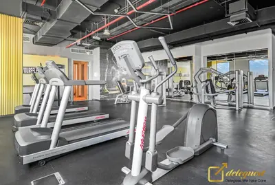 a gym with several treadmills and a treadmill at Stylish Studio with City Views in Dubai Hills in Dubai