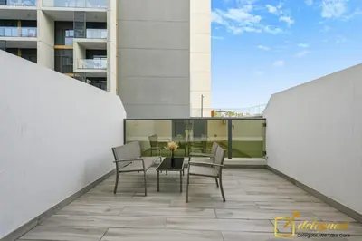 a balcony with a table and chairs on a building at Stylish Studio with City Views in Dubai Hills in Dubai