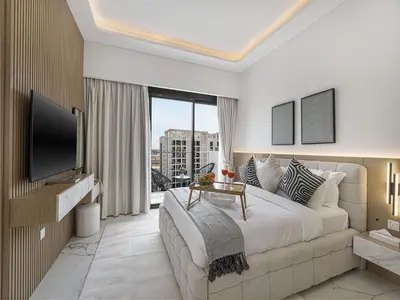 a bedroom with a large bed and a large window at Livin' Holidays - Studio - Azizi Elegant Studio in Dubai