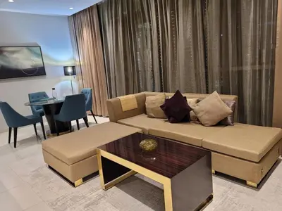 a living room with a couch and a table at Downtown Dubai Burj Khalifa View 2 BHK Dubai Mall in Dubai