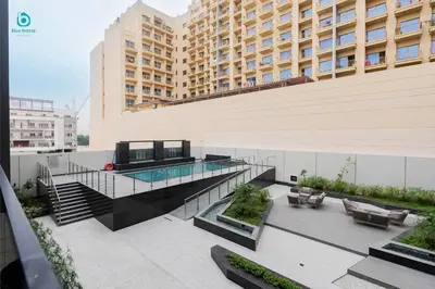 a balcony of a building with a swimming pool at Blue Breeze - Stylish 1 BR in JVC Al Serh Residence in Dubai