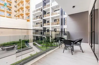 a balcony with black chairs and a table on a building at Blue Breeze - Stylish 1 BR in JVC Al Serh Residence in Dubai