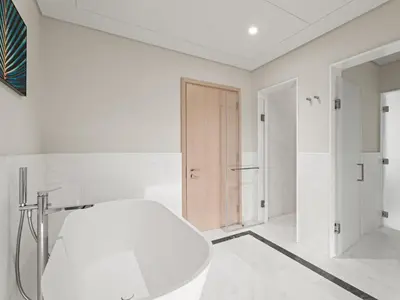 a white bathroom with a shower and a sink at Luxe Island Retreat 1BR in Palm-14 in Dubai