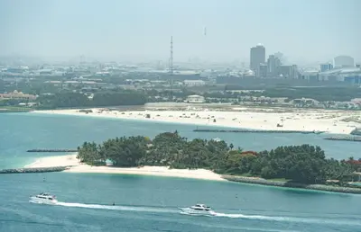 a small island in the water with two boats at Luxe Island Retreat 1BR in Palm-14 in Dubai