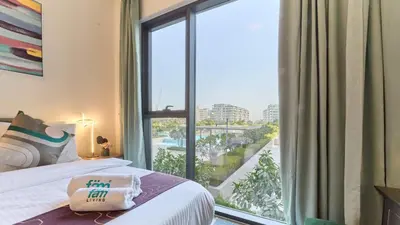 a bedroom with a bed and a large window at 1BR Dubai Hills Executive Residence Stylish Stay in Dubai