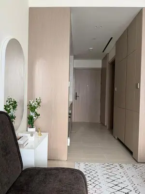 a living room with a couch and a table at Stylish Studio JVC I Epic Amenities I Near Mall in Dubai