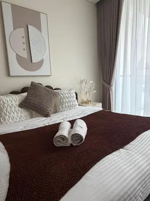 a bedroom with a bed with towels on it at Stylish Studio JVC I Epic Amenities I Near Mall in Dubai