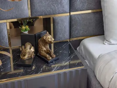 a bedroom with a table with a statue of a lion at Livin' Holidays - 1 BR - Elegant Apartment in Dubai