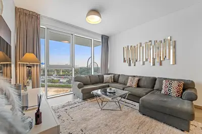 a living room with a couch and a table at Contemporary 1BR City View Apartment at 1 Residence in Dubai