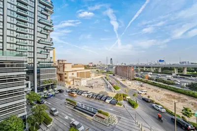 an aerial view of a city with cars and buildings at Contemporary 1BR City View Apartment at 1 Residence in Dubai