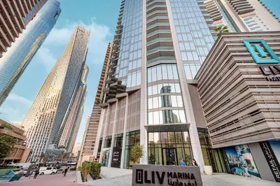 a tall building with a sign in front of it at Marina High-Floor Premium Luxury Stay at LIV Marina for up to 9 Guests with Marina Views and Exceptional Amenities in Dubai
