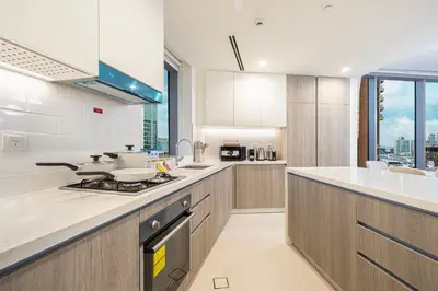 a kitchen with white counters and a stove top oven at Marina High-Floor Premium Luxury Stay at LIV Marina for up to 9 Guests with Marina Views and Exceptional Amenities in Dubai