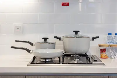 two pots and pans sitting on top of a stove at Marina High-Floor Premium Luxury Stay at LIV Marina for up to 9 Guests with Marina Views and Exceptional Amenities in Dubai
