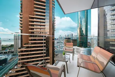 a balcony with chairs and a view of a city at Marina High-Floor Premium Luxury Stay at LIV Marina for up to 9 Guests with Marina Views and Exceptional Amenities in Dubai