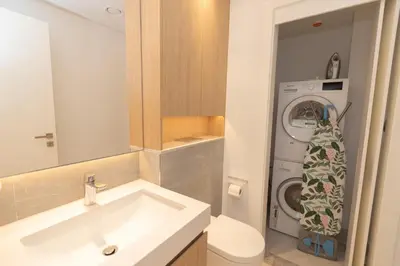 a bathroom with a sink and a washing machine at 1 BDR Ellington House, Dubai Hills in Dubai