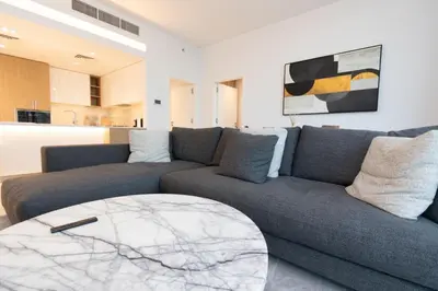 a living room with a couch and a table at 1 BDR Ellington House, Dubai Hills in Dubai