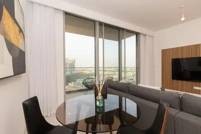 a living room with a glass table and a couch at Boutique 2BDR Ellington House, Dubai Hills in Dubai