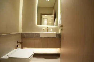 a bathroom with a sink and a toilet and a mirror at OLD The Royal Blue Jacuzzi Suite 3501 in Dubai